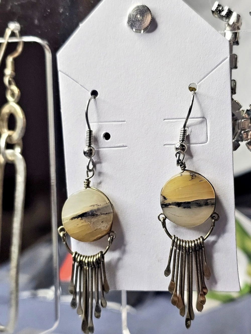 Round yellow-and-black landscape jasper with metal fringe accents